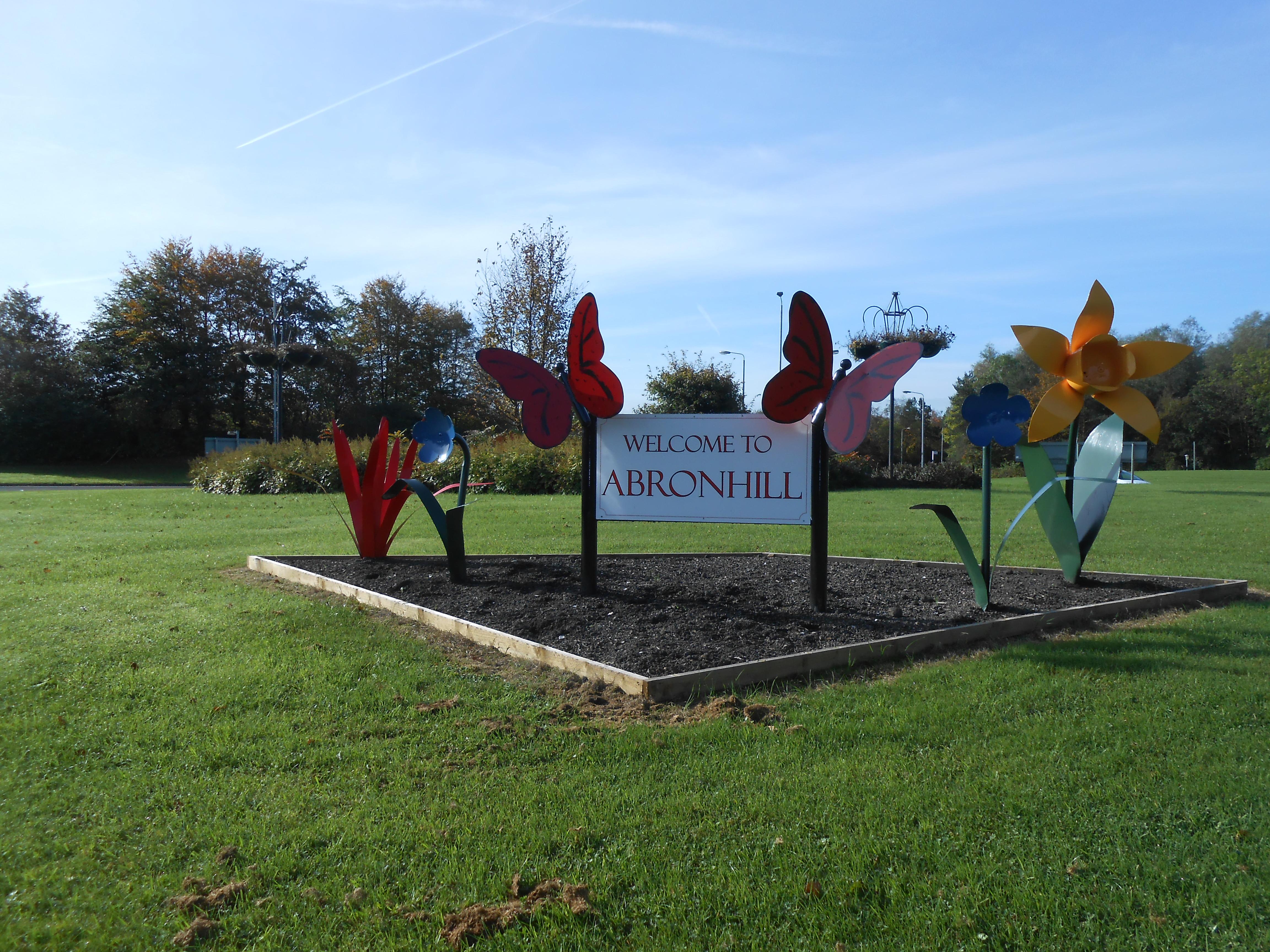 welcome to abronhill sign on roundabout